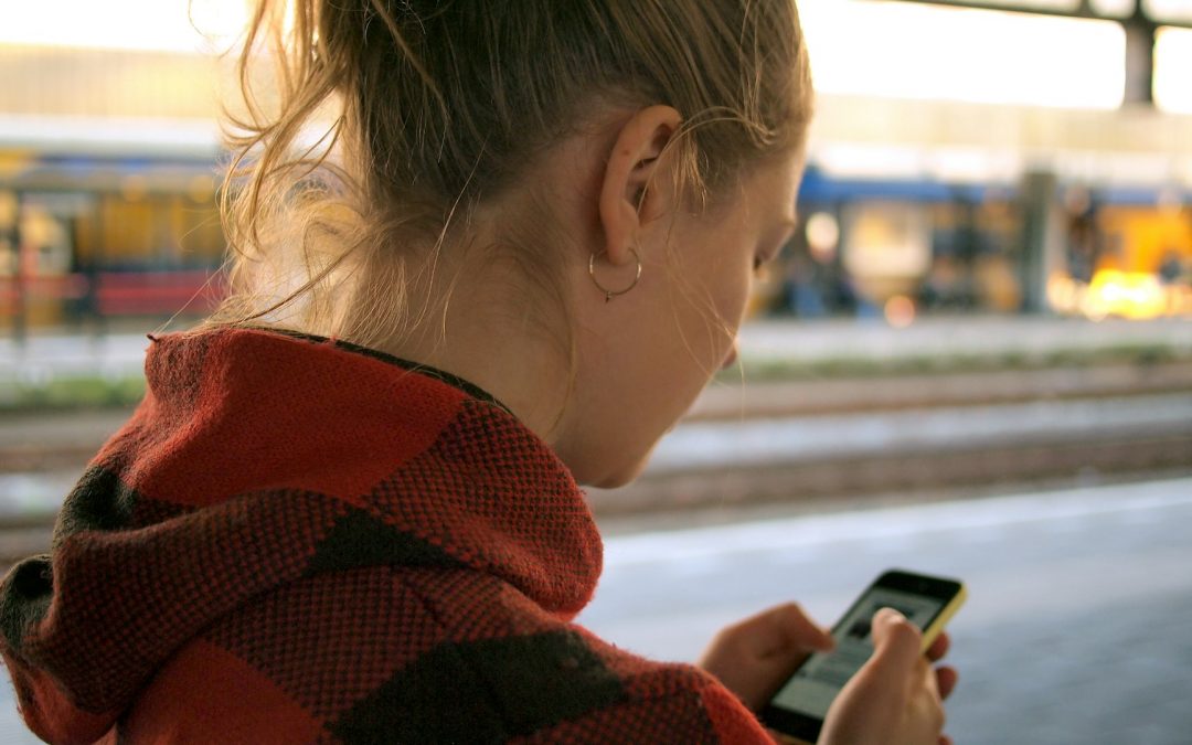 Picture of a young woman holding her phone